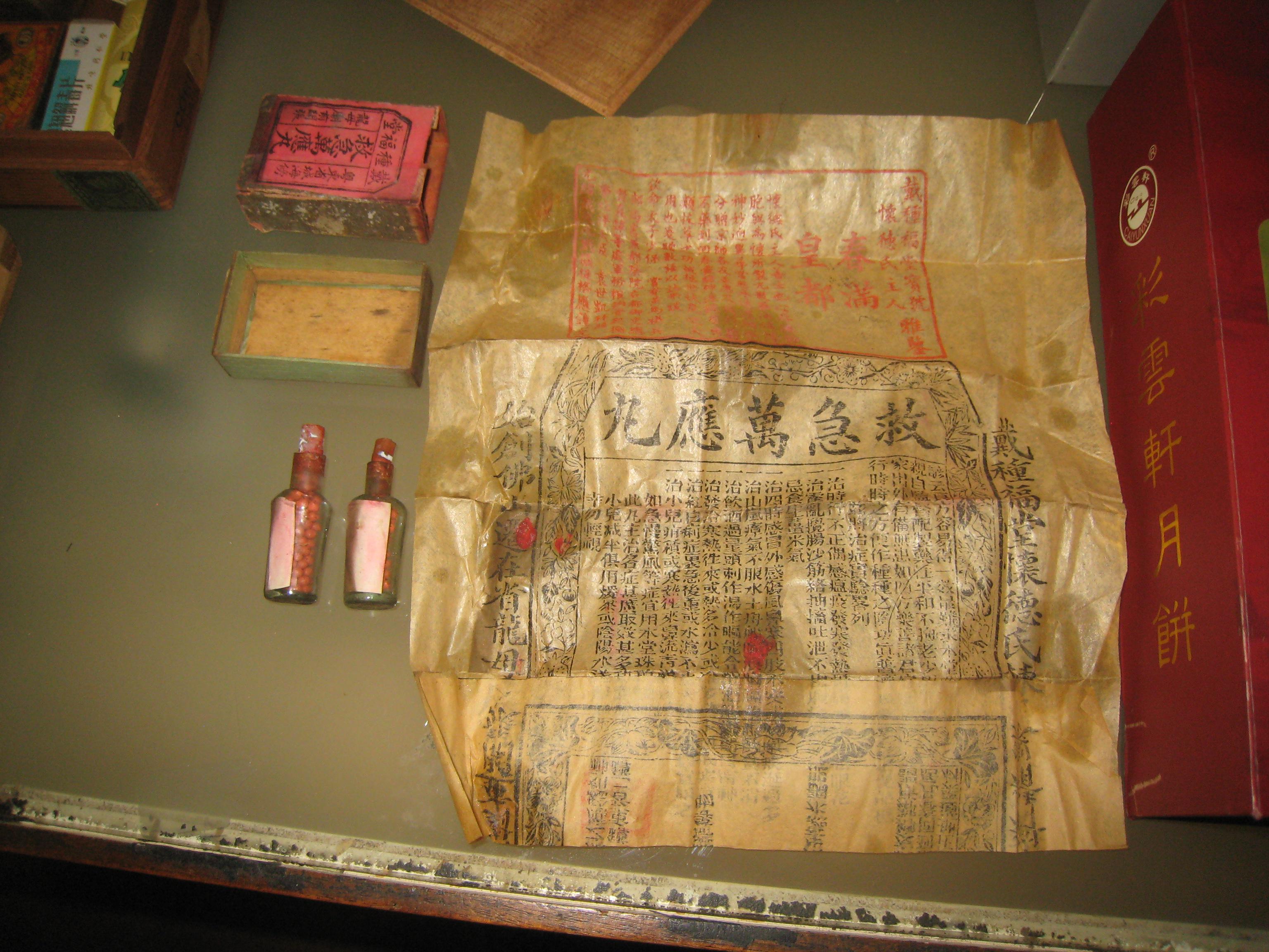 Traditional Chinese medicine bottles, boxes, and paper instructions from San Francisco Chinatown examples.