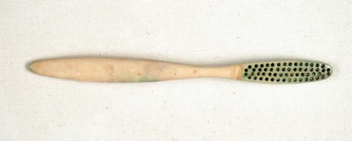 Flat bone toothbrush handle from the Market Street Chinatown exhibit.